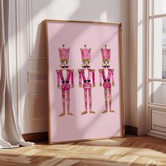 three nutcrackers in pink and gold are standing next to each other on the floor