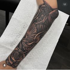 a person with a black and grey tattoo on their arm