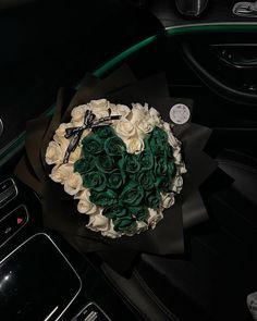 a bouquet of roses sitting on top of a car dashboard next to a steering wheel