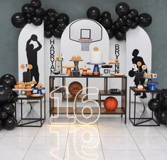 a basketball themed birthday party with black and white decorations, balloons, and sports items