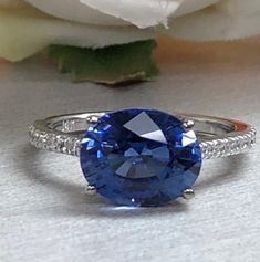 Oval Ceylon Blue Sapphire And Genuine Diamond Ring Set Horizontal In 14k White Gold #5777 by InfinityJewelersUSA on Etsy Blue Topaz Ring In 14k White Gold, Blue Cubic Zirconia Round Band Jewelry, Dazzling Oval Sapphire Promise Ring, Round Sapphire Gemstones For Fine Jewelry, Round Sapphire Fine Jewelry, 14k White Gold Jewelry With Sapphire In Round Band, Oval Sapphire Gemstone With Halo Setting, Blue Sapphire Ring With Diamond, Fine Jewelry With Cubic Zirconia And Side Stones