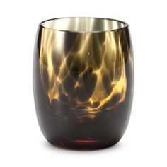 a black and gold glass vase sitting on top of a table