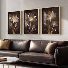 a living room with two couches and paintings on the wall above them, along with a coffee table