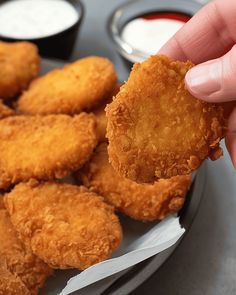 fried food on a plate with dipping sauces