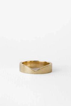 a gold ring with an irregular shaped band