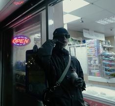 a man standing in front of a store window