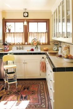 the kitchen is clean and ready to be used for cooking or baking, with an area rug on the floor