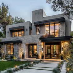 a modern house with stone and glass exterior