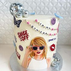 a white cake decorated with an image of a woman wearing sunglasses