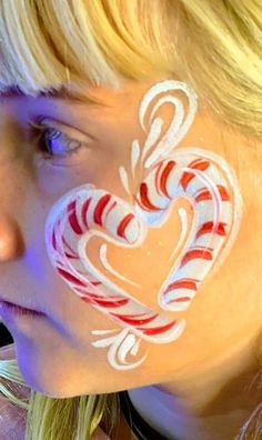 Snow Flake Face Painting, Holly Face Paint, Santa Hat Face Paint, Santa Face Painting, Cute Christmas Face Paint, Christmas Facepainting Ideas, Christmas Kids Face Painting, Simple Christmas Face Painting For Kids, Candy Cane Face Paint