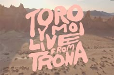 the words live from trona written in pink on a desert landscape