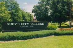 grove city college sign in front of trees and bushes