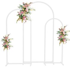 a white metal arch with flowers on it