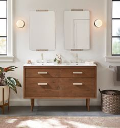 a bathroom with two sinks and mirrors in it