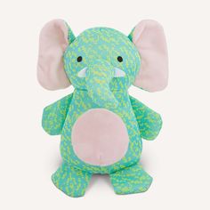 an elephant stuffed animal sitting up against a white background