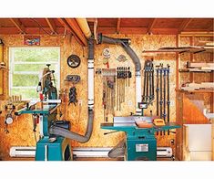 a workbench with lots of tools hanging on the wall