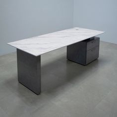 a white marble top desk in an empty room