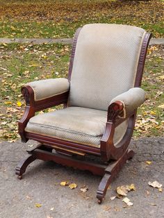 an old wooden rocking chair sitting on the ground