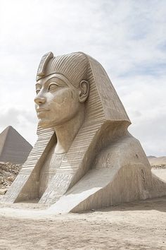 the sphinx statue is in front of the pyramids