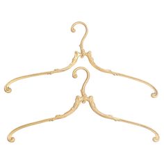 a gold metal hanger with ornate designs