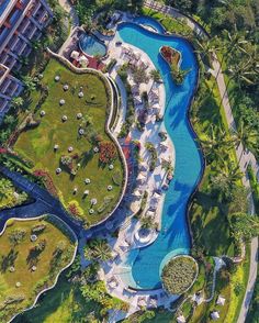 an aerial view of the resort and pool area with many lawns, trees, and water features