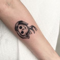 a woman's arm with a skeleton tattoo on it