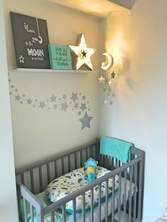 a baby's room with a crib and stars on the wall above it