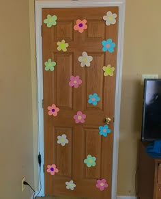 a wooden door decorated with flowers in the shape of flower petals on it's side