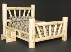 a bed made out of logs with no headboard and foot board on the side