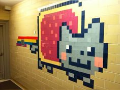 the wall is made out of legos and has an image of a cat on it