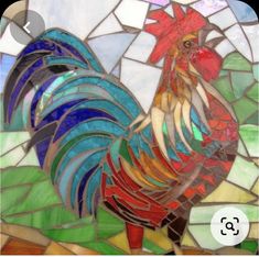 a stained glass rooster is standing on the ground