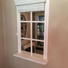 an open window in the wall with blinds on it