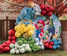 an inflatable mario balloon arch with balloons on it and other decorations around it