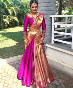 a woman in a pink and gold sari