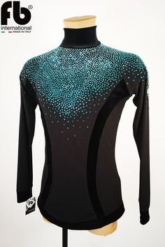 a black top with blue dots on the front and back, sitting on a mannequin