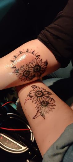 two people with tattoos on their arms and one has a sunflower tattoo on the arm