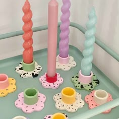 there are many different colored candles on the tray