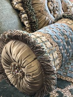 several pillows are stacked on top of each other in different patterns and colors, along with one another