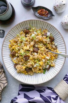 a white plate topped with rice and vegetables next to other dishes on top of a table