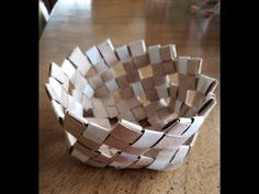 a paper basket sitting on top of a wooden table