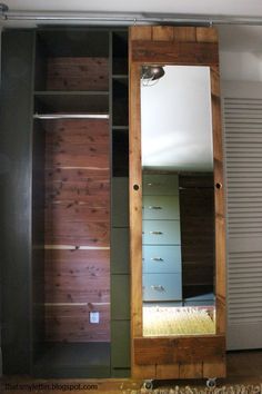 an empty closet with a mirror and drawers