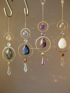 an array of different colored stones hanging from hooks