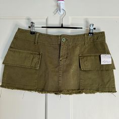 Free People - We The Free Cargo Micro Mini Skirt Condition: New With Tags, Price Has Been Cut Off (Originally $88) Color: Olive Green/ Military Green Size: 6 Measurements: Waist: 16 In. Length: 10 In. Details: Two Side Pockets Low Rise Distressed Hem Khaki-Like Material Soft! Green Mini Cargo Skirt For Spring, Kharki Cargo Skirt, Green Cotton Skort With Pockets, Short Green Skirt With Pockets, Cheap Green Relaxed Mini Skirt, Casual Green Mini Cargo Skirt, Fitted Green Mini Cargo Skirt, Green Mini Cargo Skirt In Cotton, Strapless Denim Dress