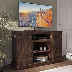 a flat screen tv sitting on top of a wooden cabinet