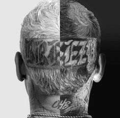 the back of a man's head with tattoos on his face and neck area