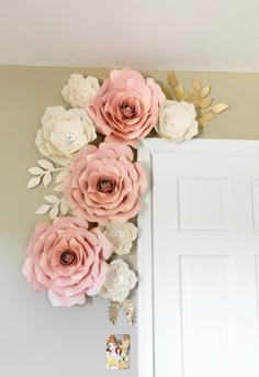 some paper flowers are hanging on the wall