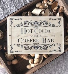 there is a sign that says hot cocoa and coffee bar on the table next to nuts