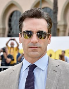 a man wearing sunglasses and a suit