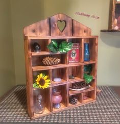 a wooden shelf filled with assorted items on top of a table