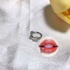 a close up of a person's lips and nose with a ring on it